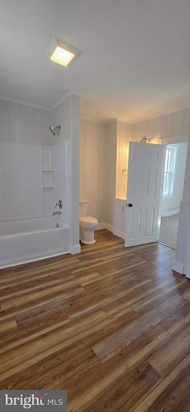 full bathroom featuring toilet, shower / washtub combination, and wood finished floors