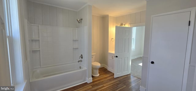 full bathroom with vanity, wood finished floors, bathing tub / shower combination, crown molding, and toilet