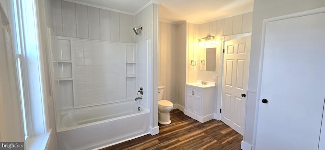 full bathroom with toilet, ornamental molding, wood finished floors, shower / bathing tub combination, and vanity