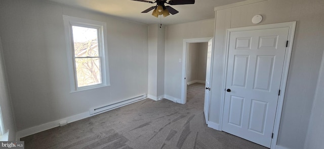 unfurnished bedroom with baseboards, a ceiling fan, carpet, and a baseboard radiator