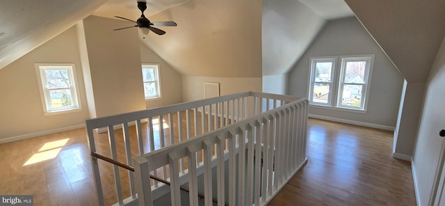 bonus room featuring vaulted ceiling, wood finished floors, and baseboards