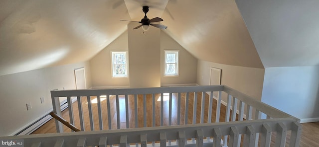 bonus room featuring a baseboard radiator, lofted ceiling, and wood finished floors