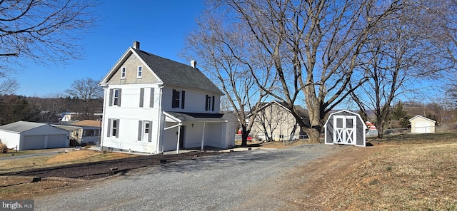 exterior space featuring an outbuilding, a shed, and fence