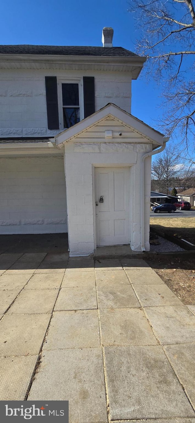 garage featuring concrete driveway