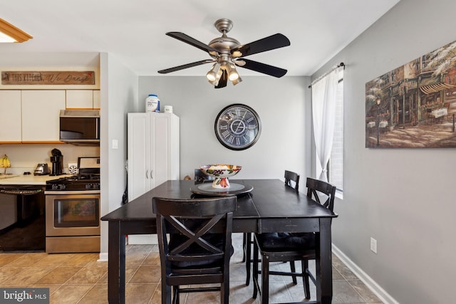 dining area with light tile patterned floors, baseboards, and ceiling fan