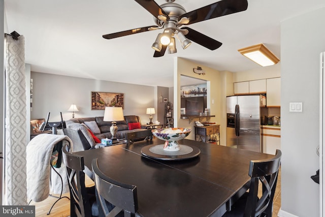 dining room with light wood-type flooring and a ceiling fan