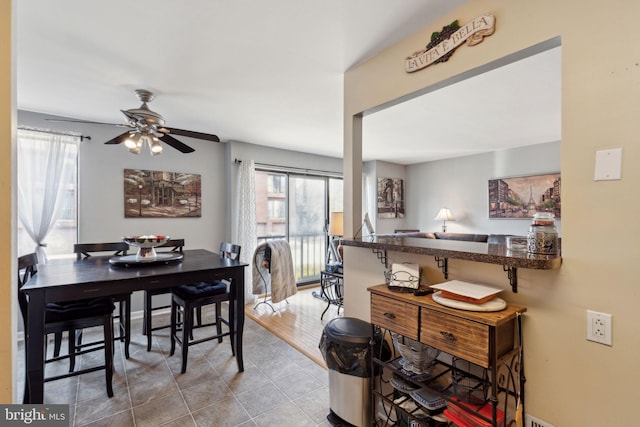 tiled dining room with ceiling fan