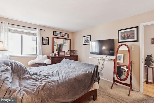 bedroom featuring baseboards and carpet