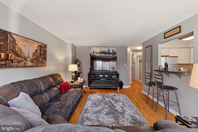 living room with light wood-style floors and baseboards