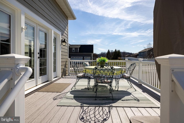 wooden deck featuring outdoor dining area