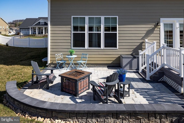 view of patio / terrace featuring a fire pit and fence