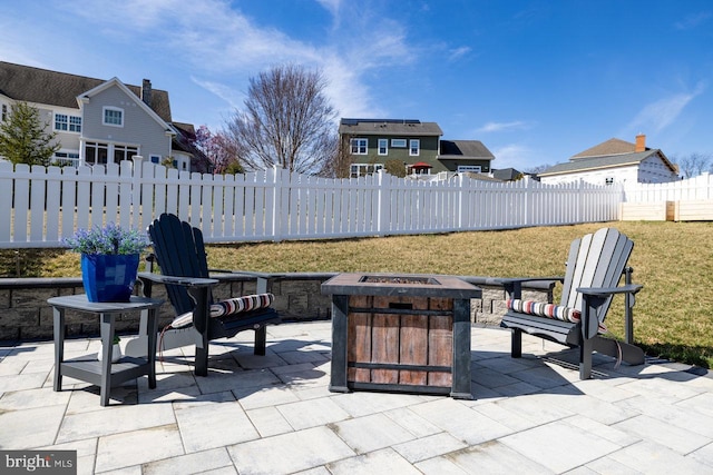 view of patio featuring fence and a fire pit