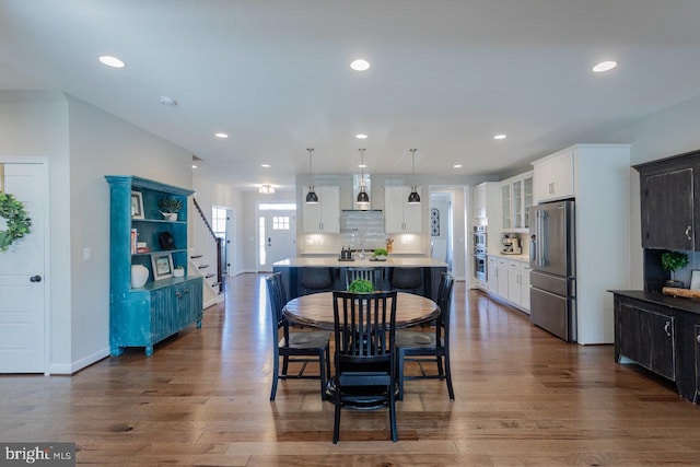 dining room featuring dark wood-style floors, baseboards, and recessed lighting