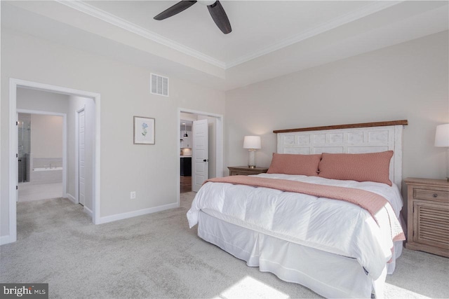 bedroom featuring crown molding, connected bathroom, visible vents, and carpet flooring