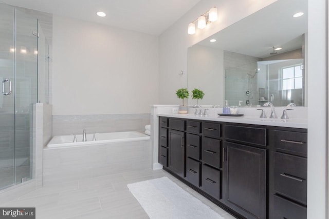 full bath with double vanity, a stall shower, a sink, and a bath