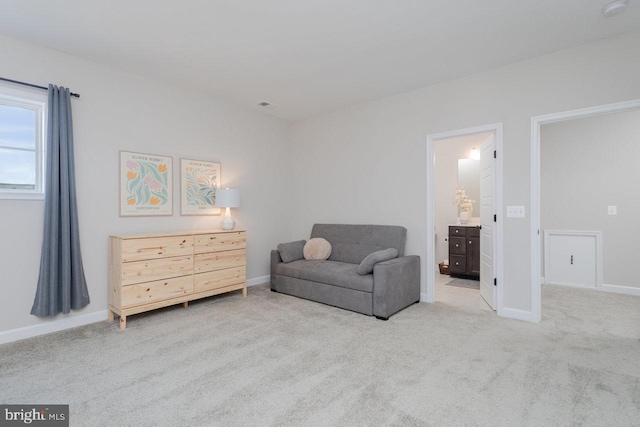 living area with carpet floors, visible vents, and baseboards