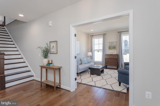 interior space featuring stairs, baseboards, wood finished floors, and recessed lighting