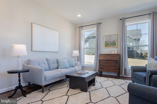 living area featuring recessed lighting, baseboards, and wood finished floors