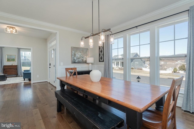 dining room featuring ornamental molding, dark wood-style flooring, and baseboards