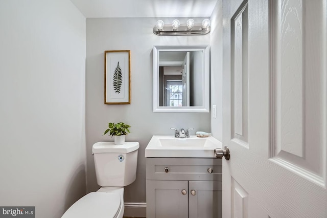 bathroom featuring toilet and vanity