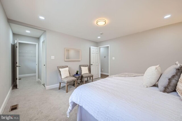 bedroom featuring baseboards, recessed lighting, visible vents, and light colored carpet