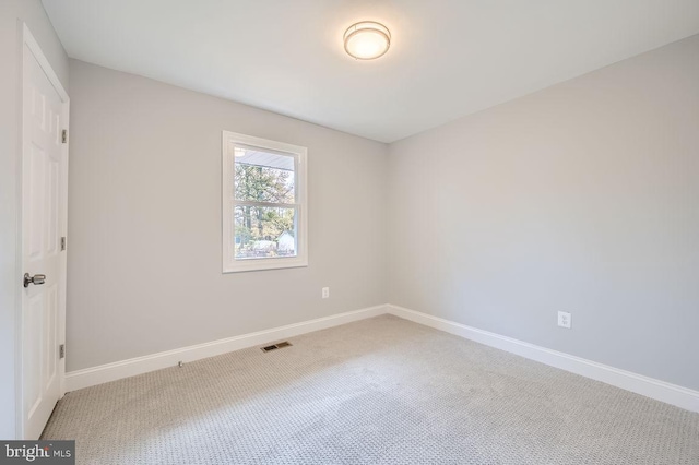 carpeted empty room with visible vents and baseboards