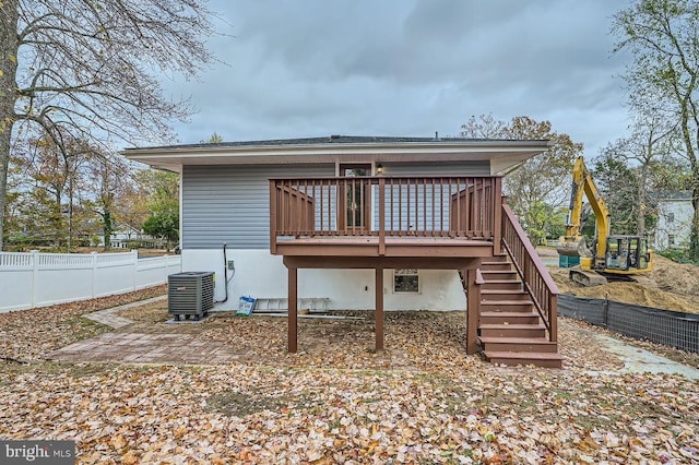 back of house featuring a deck, central AC, fence private yard, and stairs