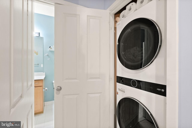 clothes washing area with stacked washer / drying machine and laundry area