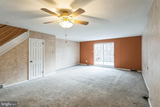 interior space featuring a ceiling fan, visible vents, and baseboards