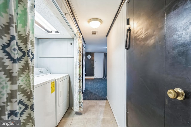 laundry area with light floors, laundry area, visible vents, and washing machine and clothes dryer