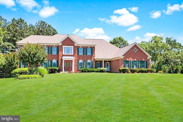 view of front of property with a front lawn and brick siding