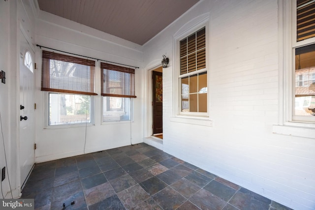 unfurnished sunroom featuring wood ceiling