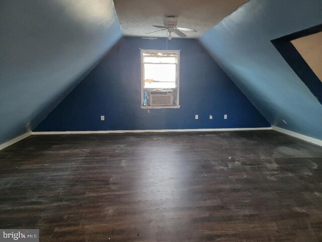 bonus room with cooling unit, a ceiling fan, wood finished floors, baseboards, and vaulted ceiling