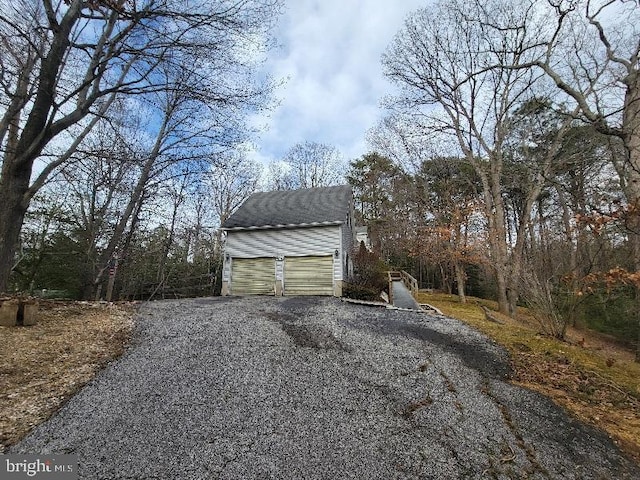 exterior space with an outbuilding and a garage