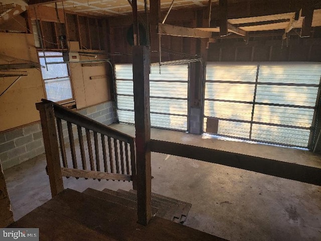 interior space with concrete block wall and concrete floors