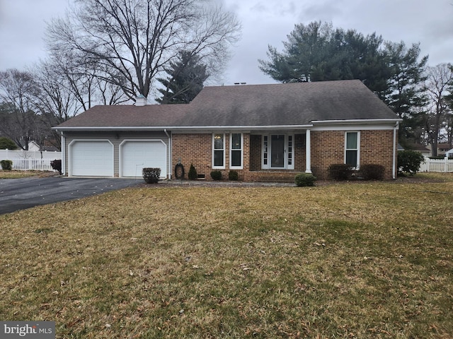 ranch-style home featuring a front yard, fence, a garage, aphalt driveway, and brick siding