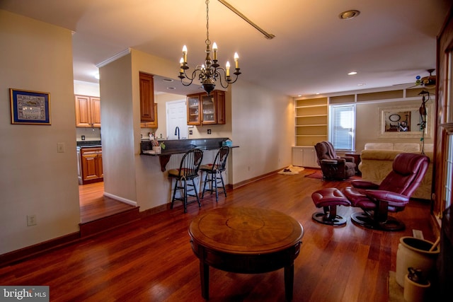 living area with dark wood-style floors, built in features, recessed lighting, and baseboards