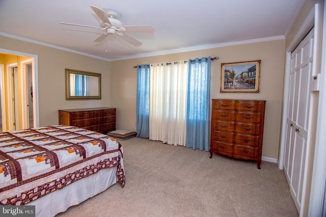 carpeted bedroom with a closet, a ceiling fan, and crown molding