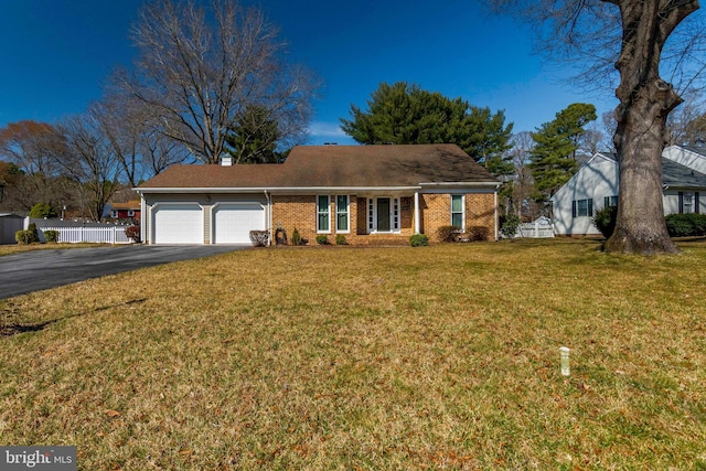 view of front facade featuring fence, driveway, an attached garage, a front lawn, and brick siding