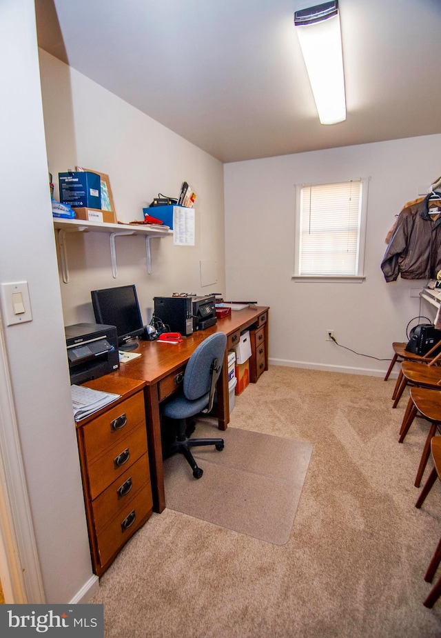 carpeted home office featuring baseboards