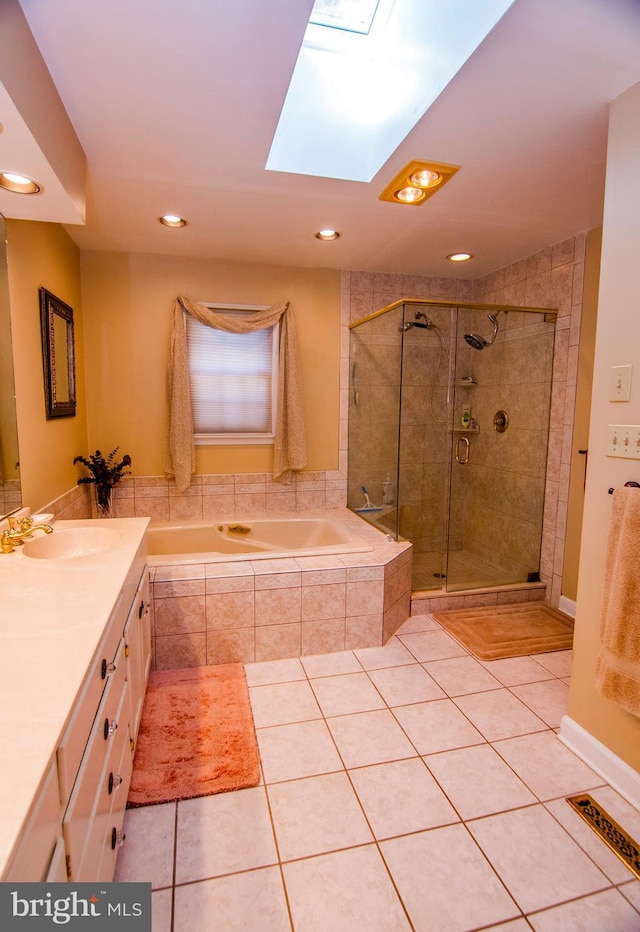 bathroom featuring tile patterned floors, a stall shower, a skylight, and a bath