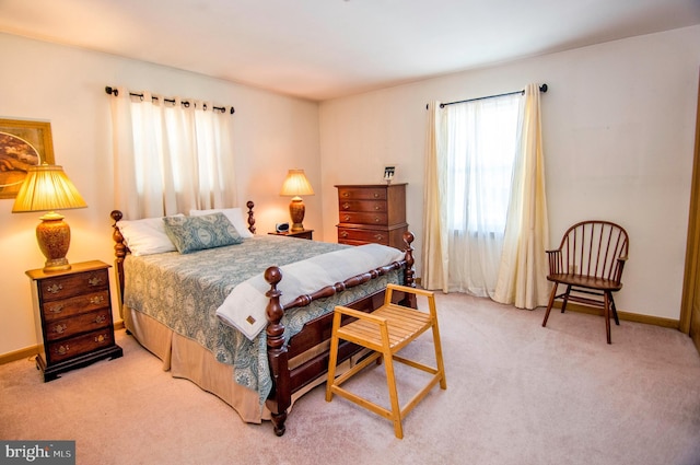 bedroom featuring baseboards and carpet