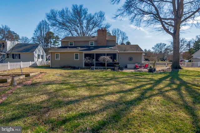 rear view of property with a patio, a vegetable garden, a fenced backyard, a chimney, and a lawn