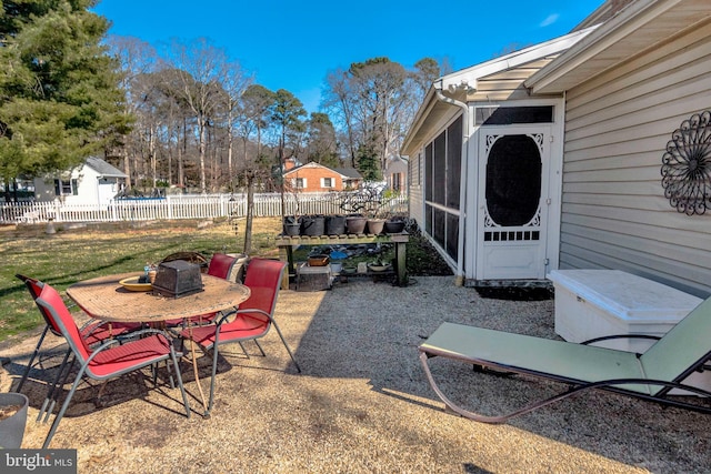 view of patio featuring outdoor dining area and fence