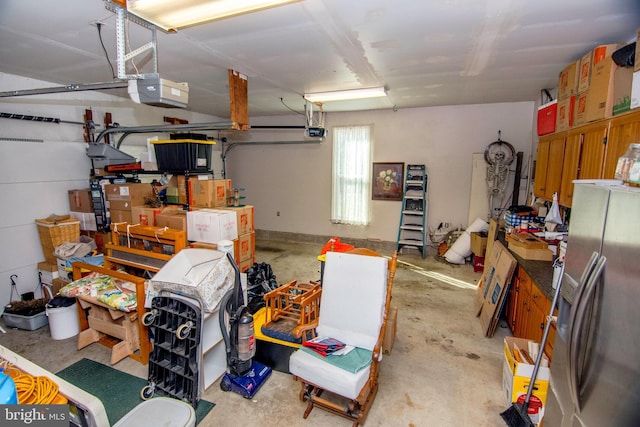 garage featuring a garage door opener and stainless steel fridge