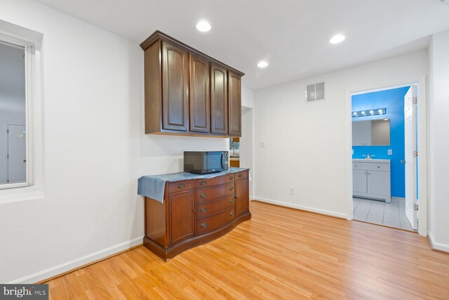 10402 Hayes Ave, Silver Spring, MD 20902 - bar with black microwave, baseboards, light wood finished floors, and recessed lighting