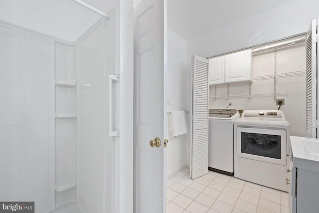 10402 Hayes Ave, Silver Spring, MD 20902 - laundry room with washing machine and clothes dryer, light tile patterned flooring, and cabinet space