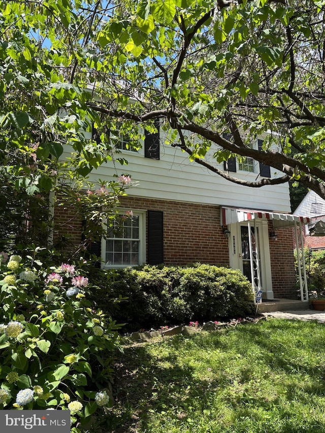 10402 Hayes Ave, Silver Spring, MD 20902 - view of front of house featuring brick siding and a front yard