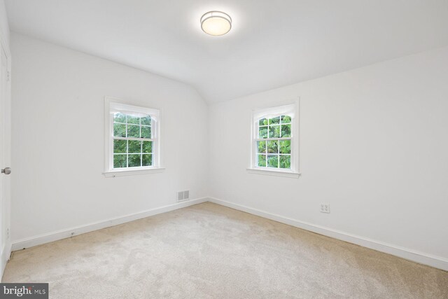 10402 Hayes Ave, Silver Spring, MD 20902 - carpeted empty room featuring vaulted ceiling and baseboards