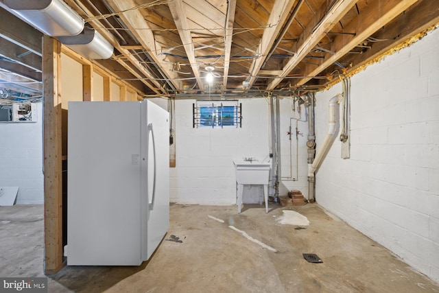 10402 Hayes Ave, Silver Spring, MD 20902 - unfinished basement with freestanding refrigerator, concrete block wall, and a sink